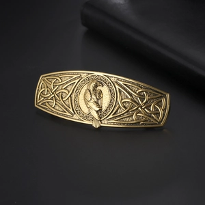 Vintage Celtic Viking raven hair clip in antique bronze finish on black leather background
