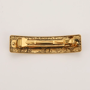 Vintage gold rectangular metal hair clip with baroque floral embossed textures