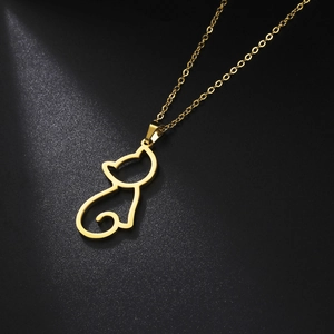 Minimalistische goldene Katzen-Halskette mit hohlgeformtem Anhänger auf schwarzem Tisch