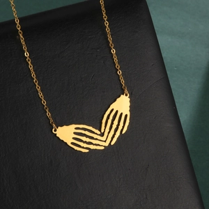 Golden titanium steel necklace featuring dual skeleton hands forming a heart shape pendant