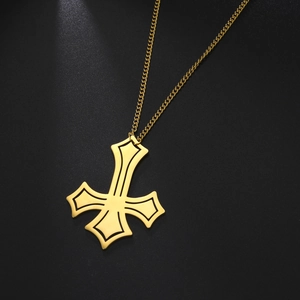 Macro shot of gold-plated stainless steel inverted cross pendant with black outline