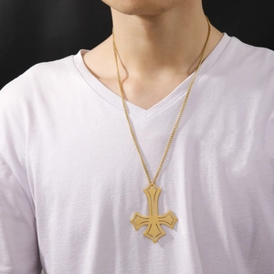 Gold plated titanium steel inverted cross pendant necklace worn on a white V-neck shirt