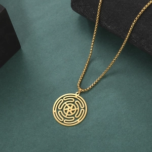Detailed close-up of golden stainless steel Hecate Wheel pendant with box chain on dark base