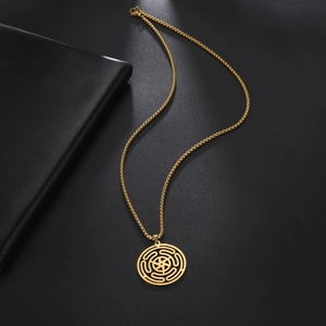 Detailed macro of golden Hecate's Wheel pendant on box chain with a polished finish