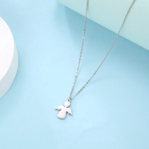Detailed view of minimalist silver stainless steel angel pendant on thin link chain