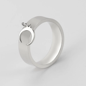 Detailed side view of a minimalist silver wide band ring with a hanging crescent moon charm