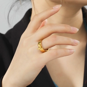Minimalist gold stainless steel wide ring featuring a dangling crescent moon charm pendant
