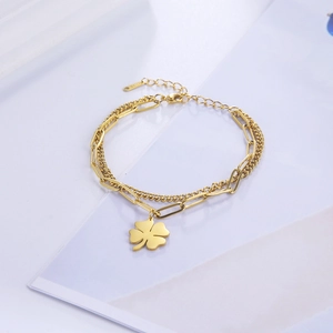Double-layered golden stainless steel chain bracelet featuring a four-leaf clover pendant