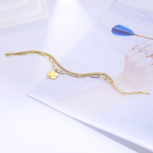 Double-layered stainless steel chain bracelet with a gold four-leaf clover pendant