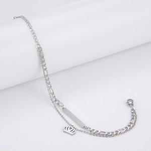 Detail of stainless steel double-layer bracelet with bar tag and crown charm