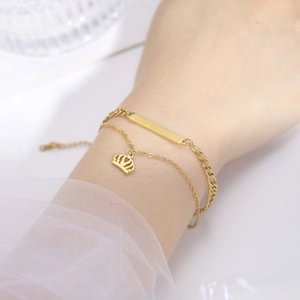 Golden double-layer baby bracelet set with crown pendant and polished nameplate bar