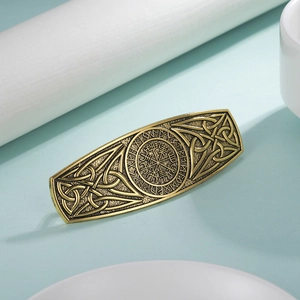 Detailed close-up of a bronze Viking Vegvisir hair clip with Celtic knot patterns