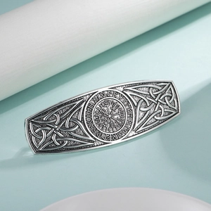 Close-up of vintage silver Viking hair clip with Vegvisir compass and rune carvings