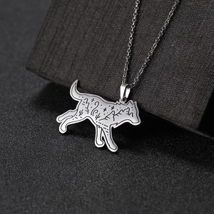 Silver stainless steel wolf necklace with engraved wilderness landscape and mountain scene