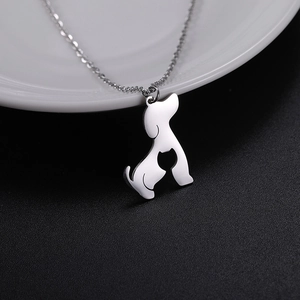 Detailed close-up of polished silver cutout dog and cat silhouette pendant necklace