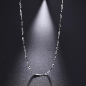 Macro detail of silver water wave Singapore chain with elegant spiral twist and metallic glow