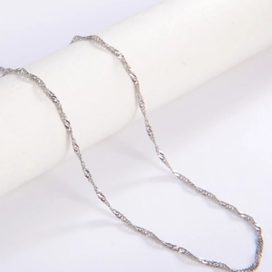 Macro detail of silver Singapore twist chain necklace with shimmering woven texture