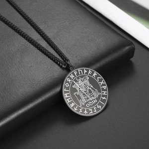 Detailed engraving of Odin on throne with runes on black matte stainless steel pendant