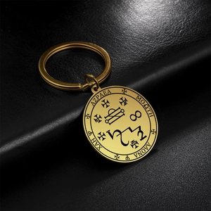 Golden stainless steel magic talisman keychain with mystical circular engraved patterns