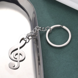 Polished stainless steel G-clef music note keychain with round ring and chain detail