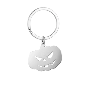 Detail of a brushed stainless steel Halloween pumpkin keychain with hollow cutouts