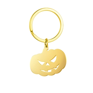 Detailed view of the gold-plated pumpkin keychain with jack-o'-lantern cutout pattern
