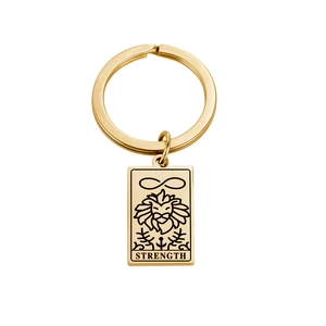 Detailed view of gold stainless steel keychain with Strength tarot card engraving