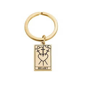 Detailed close-up of gold stainless steel keychain featuring a tarot heart and swords design