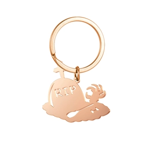 Detail of rose gold stainless steel Halloween keychain with RIP tombstone and ghost pendant