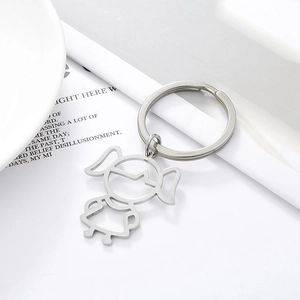 Detail shot of a minimalist stainless steel keychain with a cute hollow girl silhouette