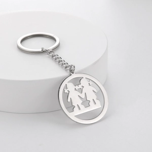Close-up of a silver stainless steel keychain featuring a hollow-cut girl character design