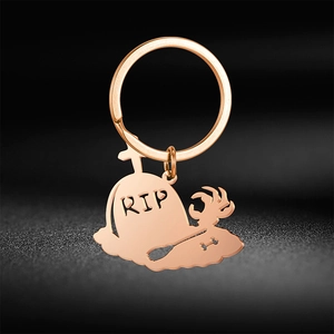 Halloween rose gold tombstone keychain with RIP text and gothic shovel skeleton design