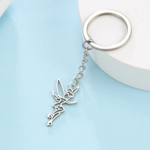 Polished stainless steel fairy silhouette keychain on a minimalist white display stand