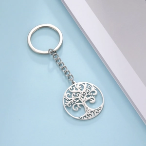 Close-up of a silver stainless steel keychain featuring a hollow tree of life pendant