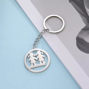 Detail of silver stainless steel keychain featuring hollow hand-holding girls silhouette