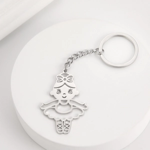 Close-up of silver hollow-out ballet girl pendant on stainless steel keychain