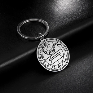 Macro detail of silver stainless steel Solomon lucky charm keychain with etched geometry