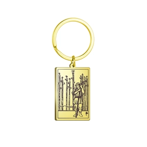 Detailed close-up of golden stainless steel Nine of Wands tarot charm on a keychain
