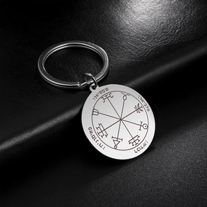 Macro view of silver stainless steel tarot sun keychain with occult seal engraving