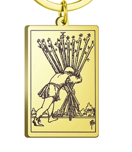Macro shot of Ten of Wands tarot card rectangular golden pendant keychain accessory