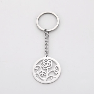 Detailed view of silver stainless steel keychain with hollow rose and leaf pattern