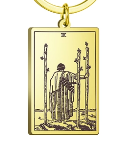 Macro detail of Three of Wands tarot charm with golden finish and engraved artwork