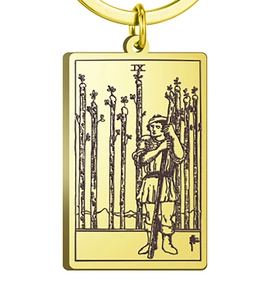 Detailed engraving of Nine of Wands Tarot design on a golden rectangular pendant charm