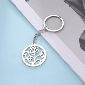 Polished stainless steel keychain featuring a hollowed-out rose flower and leaf pendant