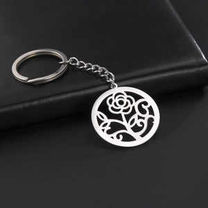 Detail of silver stainless steel keychain featuring a hollow-out rose flower pendant