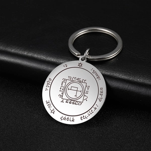Stainless steel tarot sun keychain with engraved hexagram seal on leather surface