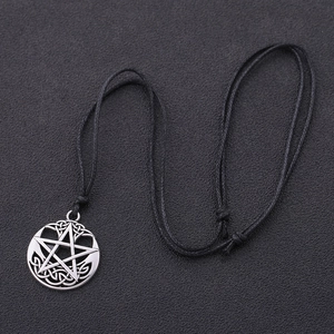 Retro punk star necklace with silver-tone celtic knot pendant on black wax cord