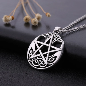 Macro shot of retro pentagram pendant with Celtic knot detail in antique silver finish