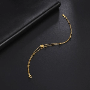 Golden double-layered stainless steel bracelet with clover pendant and small beads