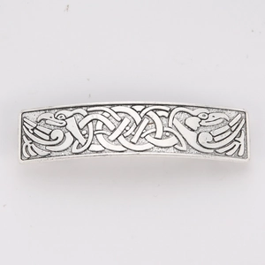 Close-up of vintage silver hair clip featuring Celtic knots and Nordic bird relief patterns